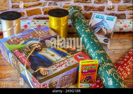 Berlin, Germany - October 27, 2022: Board games with Christmas wrapping material and decoration. Stock Photo