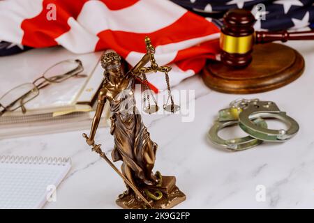 Standing at lawyer desk is statue Justice of Peace on law in court gavel surrounded by administration document folders Stock Photo