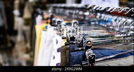 Cotton clothes on hangers Stock Photo
