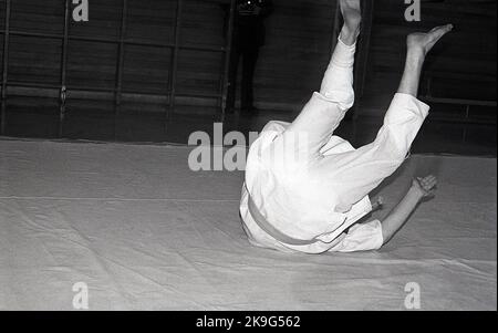 1970s, historical, inside, on a mat, two males competing in the sport of judo, a physical activity that involves two people wrestling and trying to throw each other to the ground Judo is a Japanese word meaning 'art of gentleness' and derives from the ancient Japanese martial art of jujitsu. Stock Photo