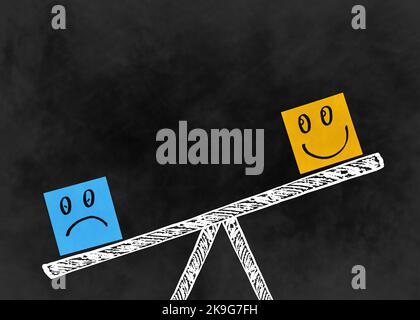 Duality concept using sticky notes with drawn doodle smiling and sad faces on seasaw on a dark background Stock Photo