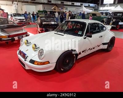 Old white sport 1973 Porsche 911 RSR Carrera speedster coupe on the red carpet. Boxer engine. Exhibit hall. Classic car show Stock Photo