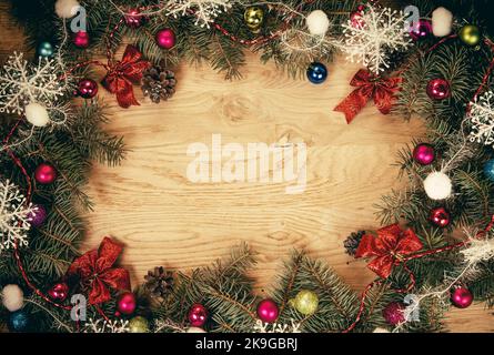 Closeup .Christmas balls and fir-tree branches on wooden background. Stock Photo