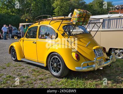 Yellow VW Beetle 1500 , produced from 1966 - 1970, diagonal rear view Stock Photo