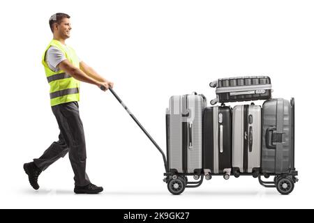 Airport worker pushing a luggage cart with suitcases isolated on white background Stock Photo