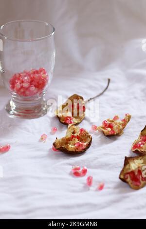 Vertical shot of pomegranate fruit and seeds ready to be made into fresh juice, showing a delicate summer aesthetics Stock Photo