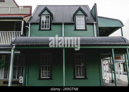 beautiful elegant old wooden house with a triangular roof on a lonely street in a small quiet town far from civilization, west neighbourhood, new Stock Photo