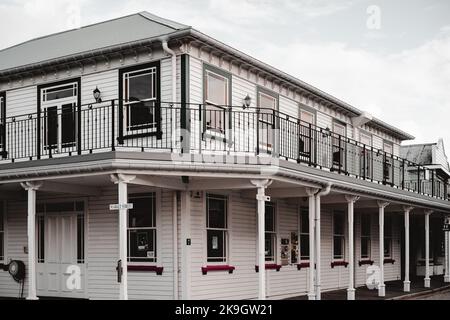 wooden building on market street with many same square windows and nice street lamps in a quiet and lonely neighborhood of a small town, west Stock Photo