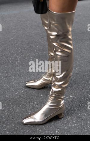Milan, Italy - September, 21, 2022: Street style outfit, woman wears silver shiny varnished block heels, over the knee boots Stock Photo