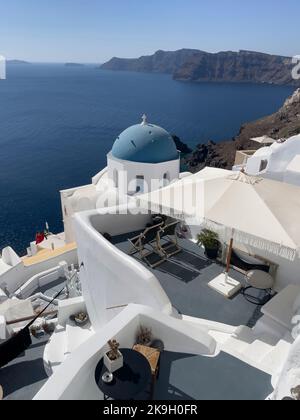 Oia, Santorini, Greece. 2022. Overview of famous blue domed buildings at Oia on the clifftops overlooking the Aegean Sea in Santorini Stock Photo