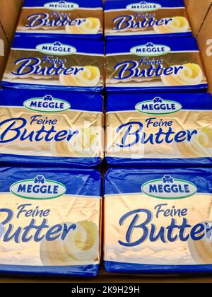 Kiel, Germany - 03. October 2022: Many golden packets of Meggle brand butter on a supermarket shelf Stock Photo