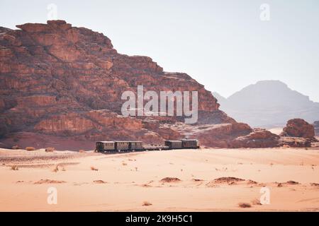 Vintage train in desert. Tourist adventure ride experience Hijaz railway train from 1916. Great arab revolt fighters attack in wadi rum. Popular activ Stock Photo