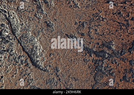 Dark stone background in rich brown and black tones. Textured backdrop to use as overlay or for added text. Stock Photo