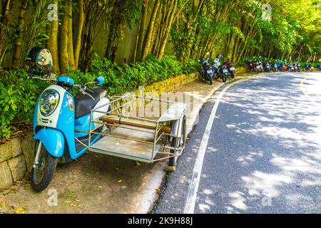 Various motorcycles mopeds and scooters in Naithon Beach Sakhu Thalang on Phuket island Thailand in Southeastasia Asia. Stock Photo