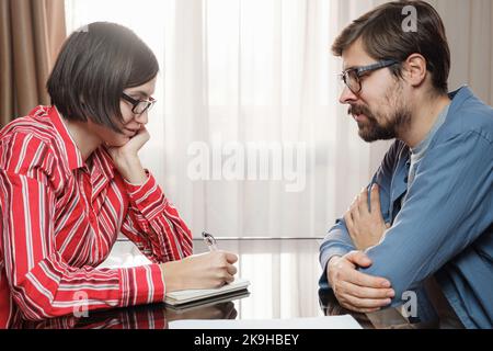 concept of home office, remote learning and online marketing. Couple working at home office , Wife Helps Husband Prepare for Job Interview Stock Photo