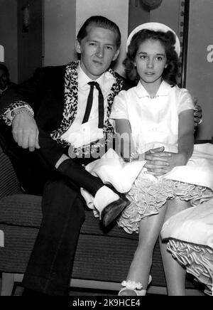 Mar. 26, 1958 - Home Office To Investigate Marriage of Jerry Lee Lewis; The Home Office is tomorrow to investigate the marriage middle of the 22 year old American Rock n Roll singer, Jerry Lee Lewis, who is over here on tour - and his 15 year old wife, Myra. Lewis and Myra are staying in London. During the week-end it was discovered that their marriage last December was fix became final. Myra's father Mr. J.W. Brown, his wife, Lois and his son, are staying at the same hotel in London. Home Office Officials will look into the marriage when Lewi's landing papers are forwarded from Immigration Of Stock Photo