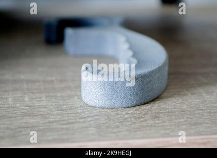 Prototype model printed with powder 3D printer close-up. Abstract black figure printed on a 3D printer from polyamide powder. Multi Jet Fusion MJF. New additive modern progressive 3D priner technology Stock Photo