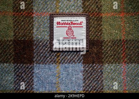 Harris Tweed label of authenticity on hand woven cloth with a tartan pattern. Stock Photo