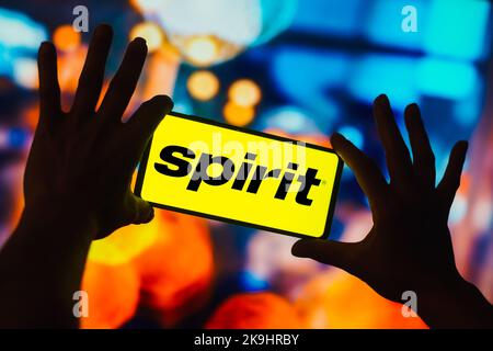 In this photo illustration, the Spirit Airlines logo is displayed on a smartphone screen. Stock Photo