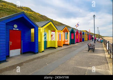A group of brightly coloured Marshalls Beach huts at the lower promenade, Saltburn-by-the-Sea, North Yorkshire, UK Stock Photo