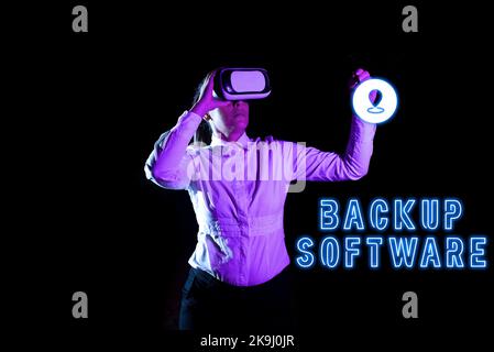 Sign displaying Backup Software. Word for boundary across which two independent systems meet and act Woman Holding Pen During Professional Training Stock Photo