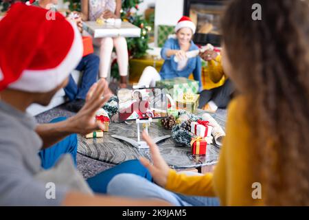 Diverse group of friends having christmas video call with african american man Stock Photo