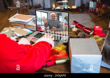 Senior caucasian man having christmas video call with senior caucasian man Stock Photo
