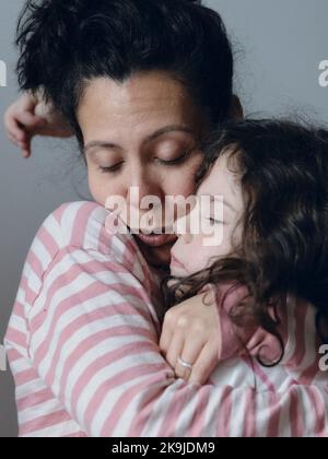 Upset little girl being consoled by mom Stock Photo