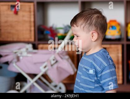 little boy playing with his toys and toy computer Stock Photo