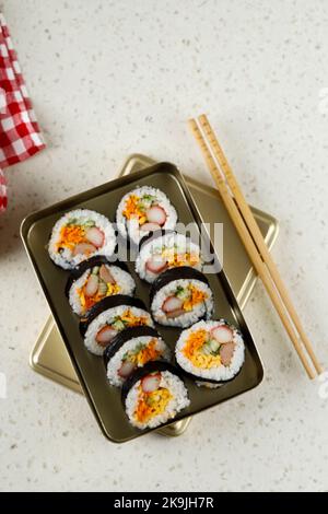 Kimbap, Korean Style Rolled Rice Sushi on Korean Traditional Metal Lunchbox Stock Photo