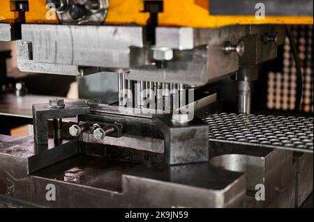 Cutting of steel blanks from metal strip on stamping press Stock Photo
