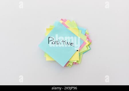 Positive word hand written on a sticky note Stock Photo