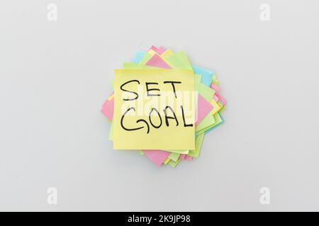 Handwritten Set Goal word written on a sticky note Stock Photo