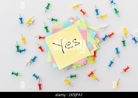 YES word hand written a yellow square sticker. Yes concept Stock Photo