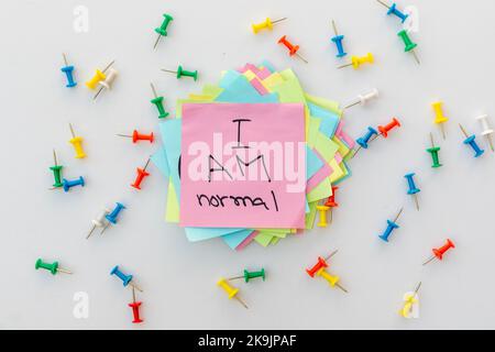 I am normal phrase handwritten on a sticky note Stock Photo