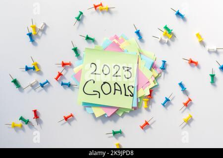 2023 goals handwritten on a yellow notepad page with isolated white background Stock Photo