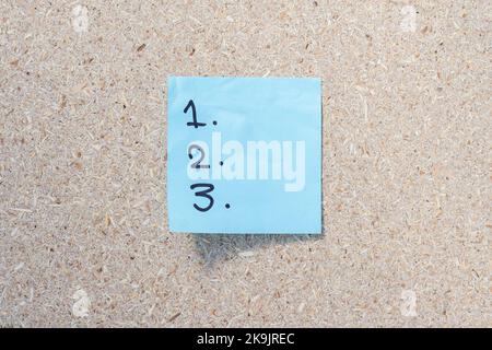 list of item or to do list 1 2 3 handwritten on a sticky note Stock Photo
