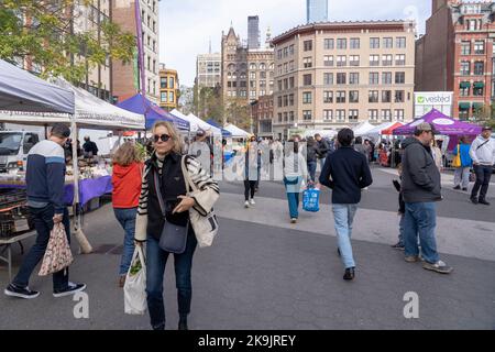 New York, USA. 28th Oct, 2022. Customers shop at a farmers market in Union Square where many local farmers sale their produce on October 28, 2022 in New York City.  New York State Senator George Borrello, Ranking Member of the Senate Agriculture Committee, said that farmers and independent analysis have concluded that the decision by New York State's Labor Commissioner to approve the Farm Labor Overtime Rules will spell the end for many NY farms and force others to scale down production, increase automation or relocate. Credit: Ron Adar/Alamy Live News Stock Photo