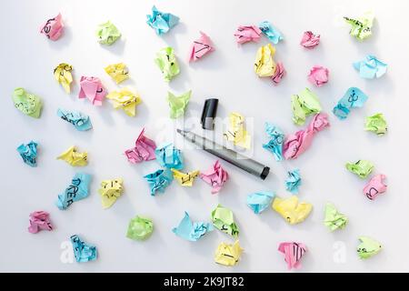 Empty note papers with a black marker and crumbled paper on white isolated background Stock Photo