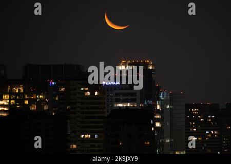 Santiago, Metropolitana, Chile. 28th Oct, 2022. The crescent moon hides at night over the buildings of Santiago, Chile. (Credit Image: © Matias Basualdo/ZUMA Press Wire) Credit: ZUMA Press, Inc./Alamy Live News Stock Photo