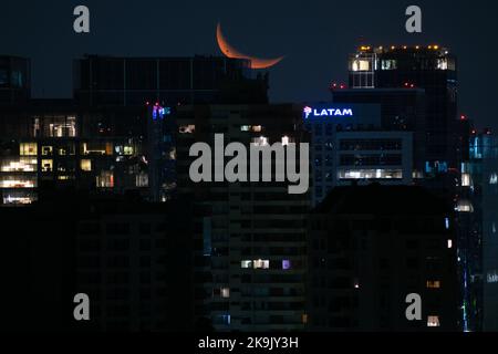 Santiago, Metropolitana, Chile. 28th Oct, 2022. The crescent moon hides at night behind the buildings of Santiago, Chile. (Credit Image: © Matias Basualdo/ZUMA Press Wire) Credit: ZUMA Press, Inc./Alamy Live News Stock Photo