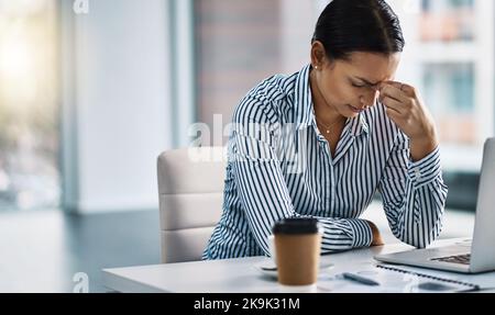 Feels like my career has reached a dead end. a young businesswoman looking stressed out while working in an office. Stock Photo