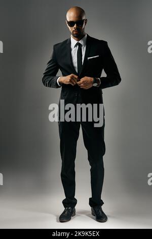 Making business look good. Studio portrait of a handsome young businessman against a gray background. Stock Photo
