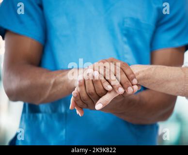 Hands, support and nurse helping patient in hospital, care and empathy for people. Healthcare, assistance and black man or doctor holding hands of Stock Photo