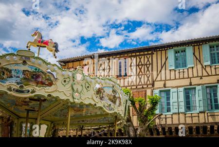 Carrousel and medieval half timbered houses in the town of Mirepoix in the south of France Stock Photo
