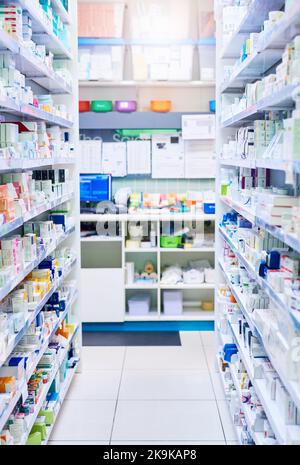 We have just the medicine for you. shelves stocked with various medicinal products in a pharmacy. Stock Photo
