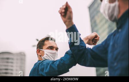 close up. two young men greeting each other with their elbows Stock Photo