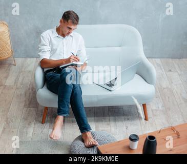 young entrepreneur making notes in a notebook. Stock Photo