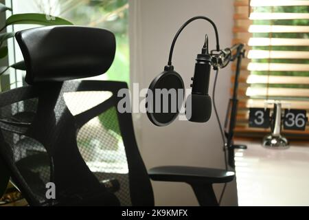 A professional condenser microphone in home studio. Entertainment, podcasts and technology concept Stock Photo