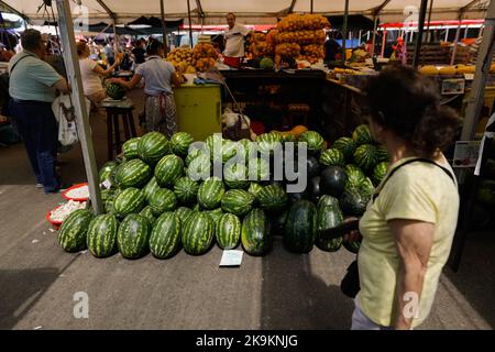 Bucharest, Romania - August 4, 2022: Shallow depth of field (selective focus) details with red watermelons for sale in a stand in Obor market in Bucha Stock Photo